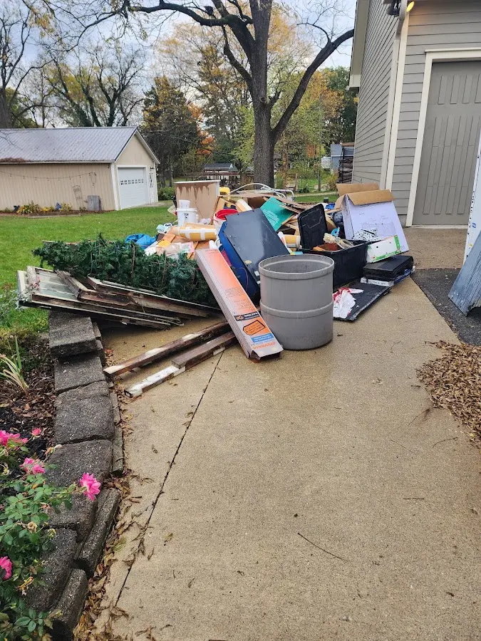 Dumpster being loaded with debris for Estate Cleanout Dumpster Rental in Taylor Lake Village